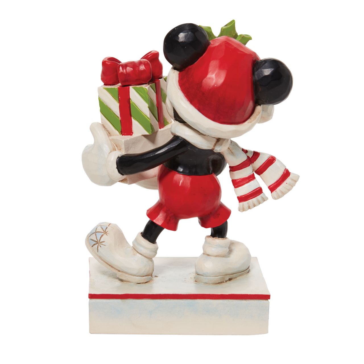 Jim Shore Christmas Mickey with Stack of Presents Figurine  Disney comes home for the holidays with this festive figurine by Jim Shore. Donning a candy cane striped scarf, Mickey wears a neighborly smile as he carries a towering stack of presents. The cheerful mouse boasts a holly brimmed Santa hat.