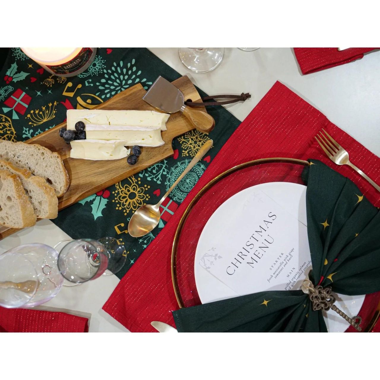 Christmas Wish Table Runner by Mindy Brownes Interiors  A beautiful table runner finished in forest green with a Christmas design that depicts some of Christmas' key elements, such as reindeer, presents, music notes, and more.