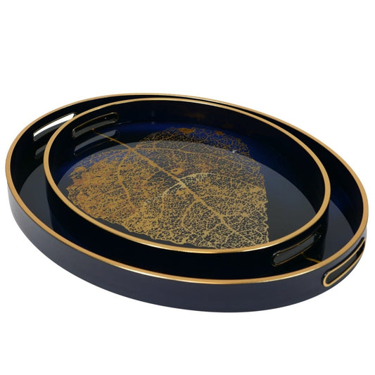 Mindy Brownes Golden Leaf Trays Set of 2  A stunning set of two oval trays in a deep midnight blue with a gold rim and golden leave design.