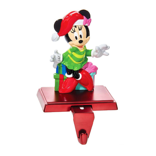 Kurt S Adler Minnie Mouse Stocking Holder  Hang up your favorite stocking this Christmas with this Disney Minnie Mouse stocking hanger from Kurt Adler. Features Minnie Mouse wearing a green dress, and a red and white Santa hat standing in front of wrapped presents.