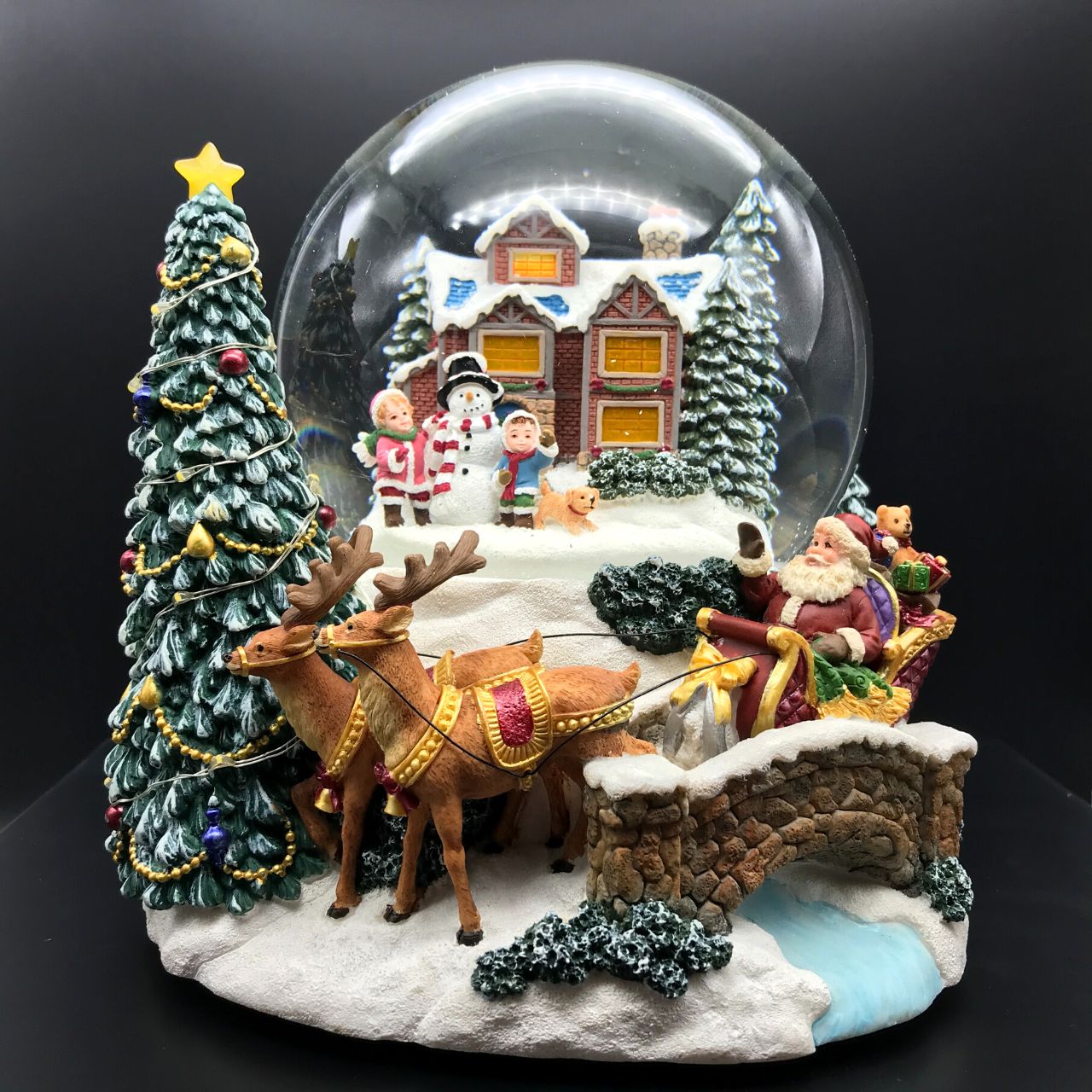 Music Box World Snow Globe Build a Snowman X-Large  Snow globe is a beautiful Christmas decoration that is treasured by people of all ages that captures the the magical moments of Christmas.  Snow globe plays “Joy to the world” while the snow swirls automatically and illumination lights up. Battery operated. Batteries not included.