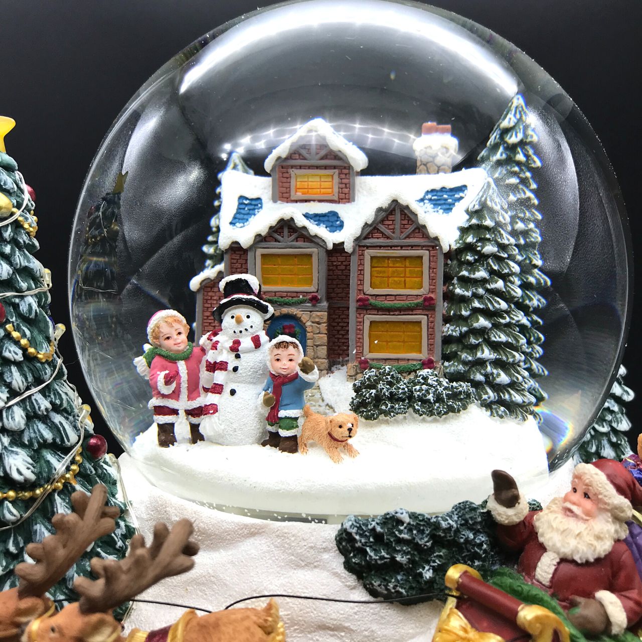 Music Box World Snow Globe Build a Snowman X-Large  Snow globe is a beautiful Christmas decoration that is treasured by people of all ages that captures the the magical moments of Christmas.  Snow globe plays “Joy to the world” while the snow swirls automatically and illumination lights up. Battery operated. Batteries not included.