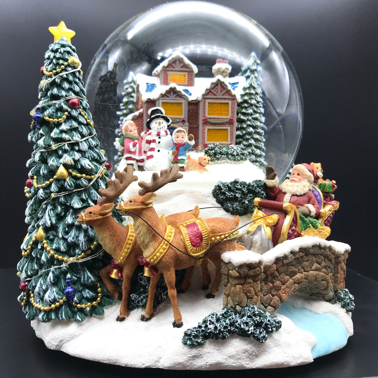 Music Box World Snow Globe Build a Snowman X-Large  Snow globe is a beautiful Christmas decoration that is treasured by people of all ages that captures the the magical moments of Christmas.  Snow globe plays “Joy to the world” while the snow swirls automatically and illumination lights up. Battery operated. Batteries not included.