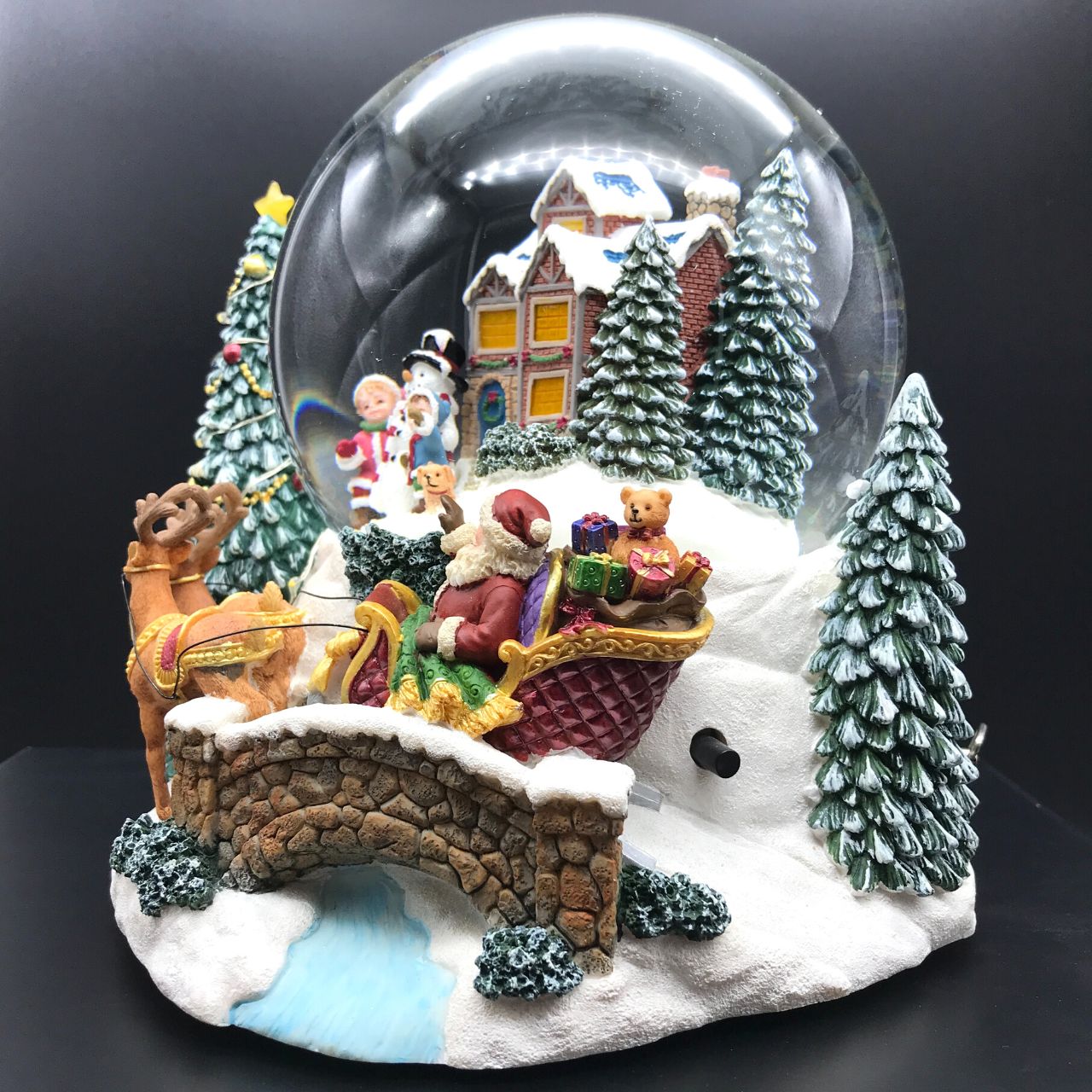 Music Box World Snow Globe Build a Snowman X-Large  Snow globe is a beautiful Christmas decoration that is treasured by people of all ages that captures the the magical moments of Christmas.  Snow globe plays “Joy to the world” while the snow swirls automatically and illumination lights up. Battery operated. Batteries not included.