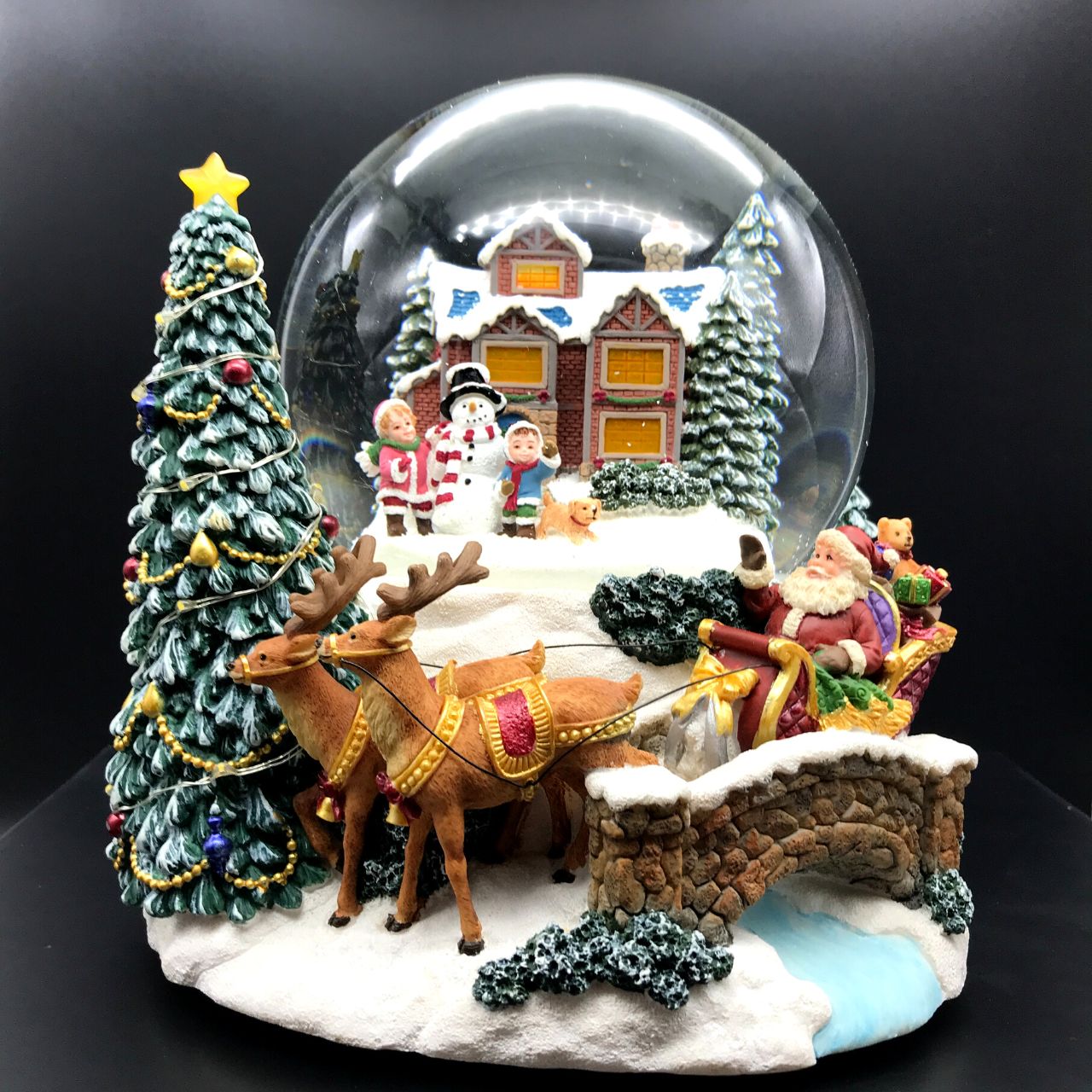 Music Box World Snow Globe Build a Snowman X-Large  Snow globe is a beautiful Christmas decoration that is treasured by people of all ages that captures the the magical moments of Christmas.  Snow globe plays “Joy to the world” while the snow swirls automatically and illumination lights up. Battery operated. Batteries not included.