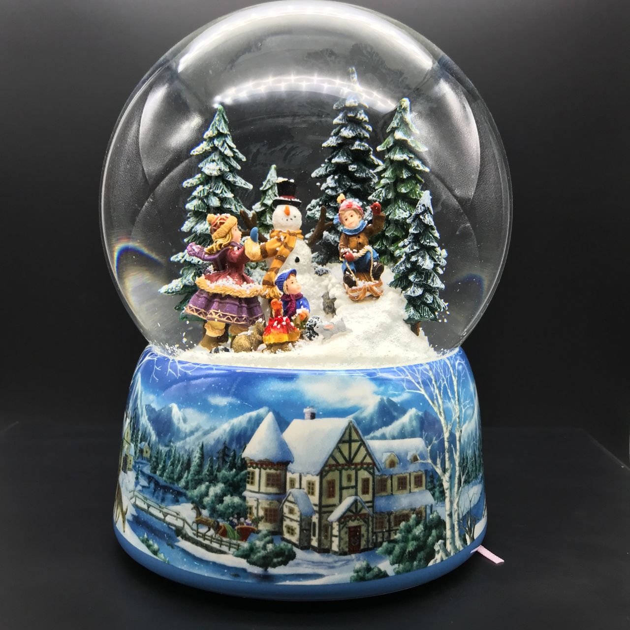 Music Box World Snow Globe Snowman - Large  Snowman snow globe plays the melody “Leise Rieselt der Schnee”. The snow swirls automatically and the camp fire lights up.  Melody: Leise Rieselt der Schnee