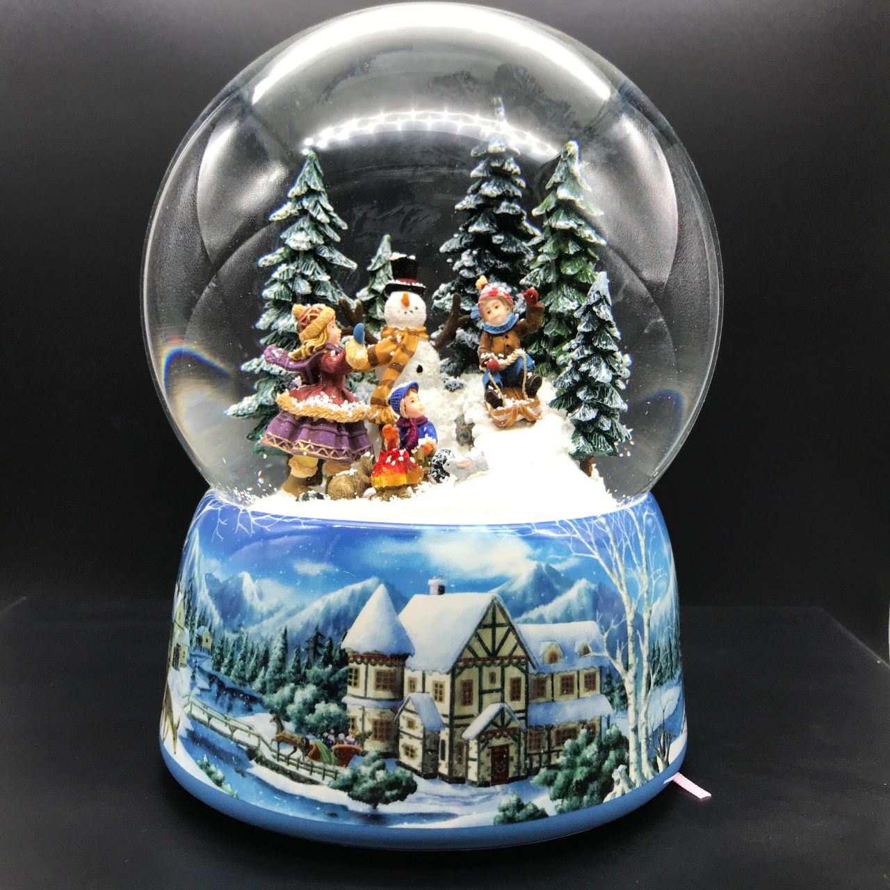 Music Box World Snow Globe Snowman - Large  Snowman snow globe plays the melody “Leise Rieselt der Schnee”. The snow swirls automatically and the camp fire lights up.  Melody: Leise Rieselt der Schnee