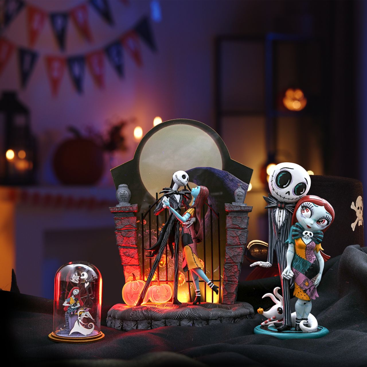 Nightmare Before Christmas Figurine  A lit up Halloween moon forms the back drop of this endearing scene from The Nightmare Before Christmas. Jack and Sally's graveyard waltz is frozen in time with only jack-o-lanterns as their witnesses. 