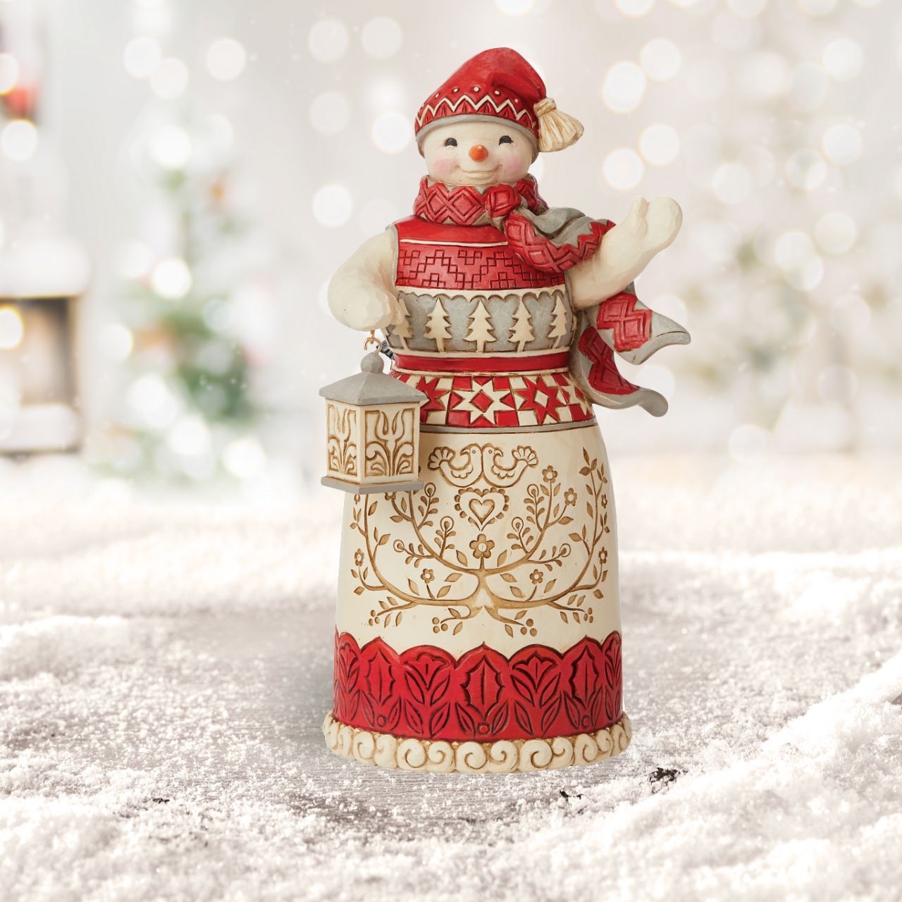 Jim Shore Heartwood Creek Nordic Noel Snowman with Lantern Figurine  Inspired by Scandinavian folk art traditions, this Jim Shore Nordic Snowman lights the way to Noel. Holding a lantern in hand, this exceptionally crafted snowman bears a robe of pattern and interlacing detail.