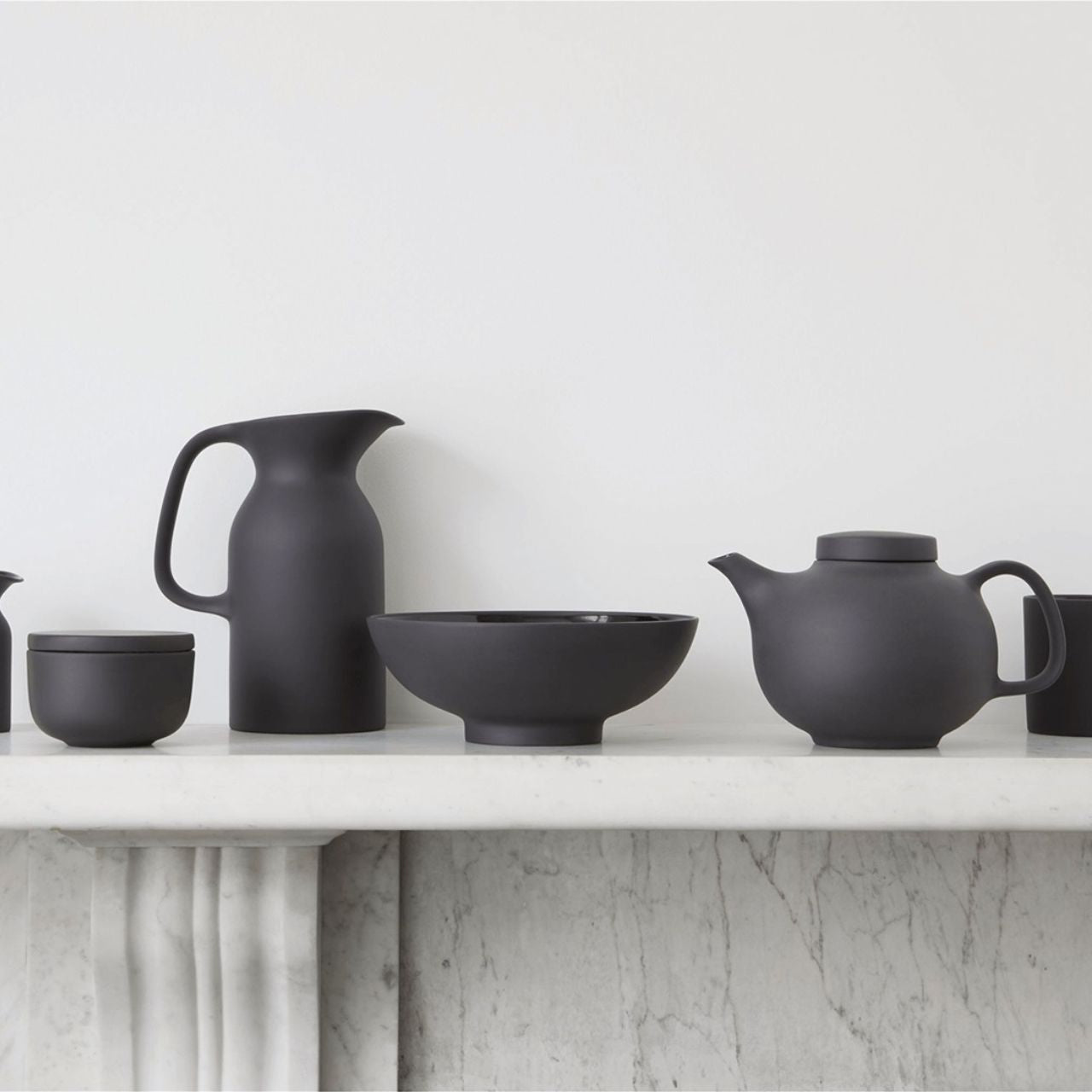 Serve fresh seasonal salad for one, a side of vegetables or some healthy snacks in this Olio Black Small Serving Bowl by Barber Osgerby. Crafted from durable stoneware, this black bowl comes in a matte graphic black glaze on the outside and contrasting glossy black glaze inside.