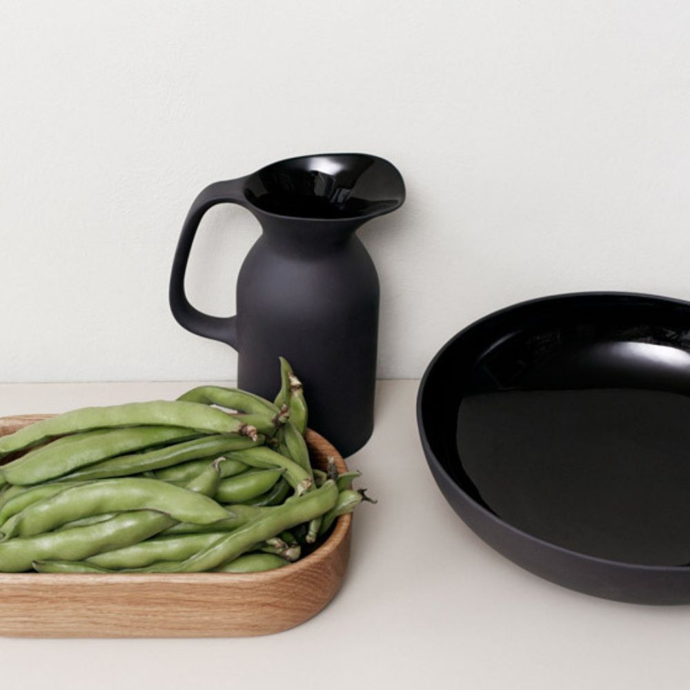Serve fresh seasonal salad for one, a side of vegetables or some healthy snacks in this Olio Black Small Serving Bowl by Barber Osgerby. Crafted from durable stoneware, this black bowl comes in a matte graphic black glaze on the outside and contrasting glossy black glaze inside.