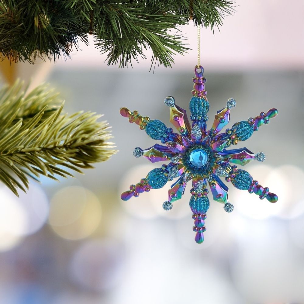 Kurt S Adler Peacock Snowflake Christmas Ornament - Blue Gemstone  Festive and unique peacock color glittered snowflake ornament is a perfect addition to any holiday or home décor! This features a blue, purple and green glittered snowflake with a blue gemstone center.