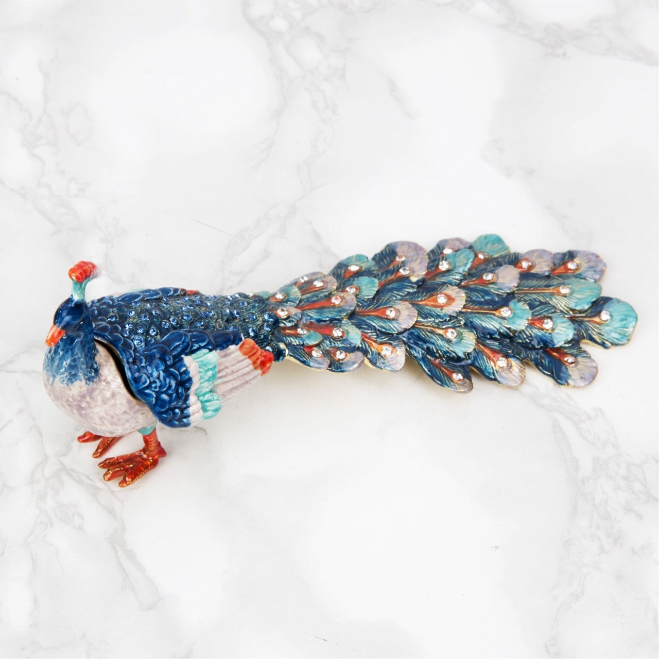 Treasured Trinkets - Peacock  A beautiful, hand painted and crystal finished peacock trinket box from Treasured Trinkets.  Painted with gorgeous blue plumage, this colourful trinket box is a wonderful ornament to complement a mantelpiece, bookcase or cabinet.