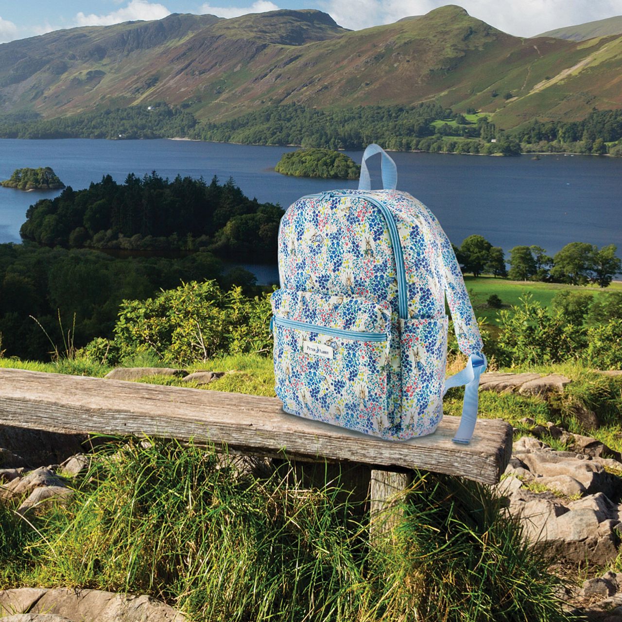 Beatrix Potter Peter Rabbit Garden Party Backpack  This classic adult backpack features a brand new design as part of our Peter Rabbit Garden Party Pop Up Collection. A large interior with an exterior zip pocket, side pockets and adjustable straps makes this the perfect accessory for those on the go. 