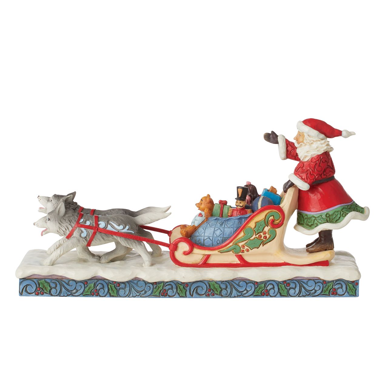 Jim Shore Santa in Dog Sled with Toys Figurine -Heartwood Creek Collection  Wood carved textures and intricately detailed designs. Unique, sometimes surprising combinations of colours - often incorporating a touch of Jim's favourite colour - purple. This magical Santa with sleigh depicts a scene of joy and wonder, Santa delivering his sleigh full of presents to Children all over the world