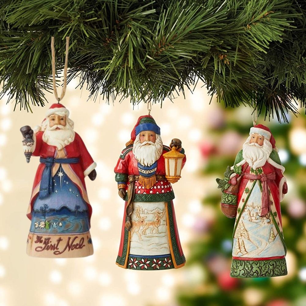 Jim Shore Heartwood Creek Santa First Noel Hanging Ornament  Designed by award-winning artist and sculptor Jim Shore for Heartwood Creek. Ornament hangs by jute rope and features a handcrafted look.