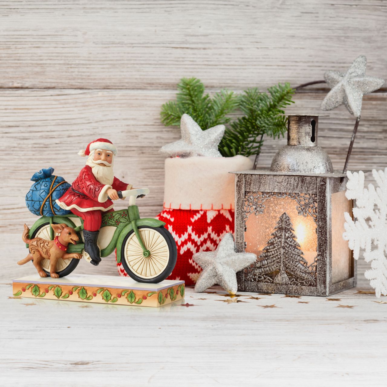 Jim Shore Heartwood Creek Santa Riding Bike Figurine  Traditional Heartwood Creek Collection; Wood carved textures and intricately detailed designs. Unique, sometimes surprising combinations of colours - often incorporating a touch of Jim's favourite colour - purple. Here we have Santa riding a bike with his trusty canine friend by his side.