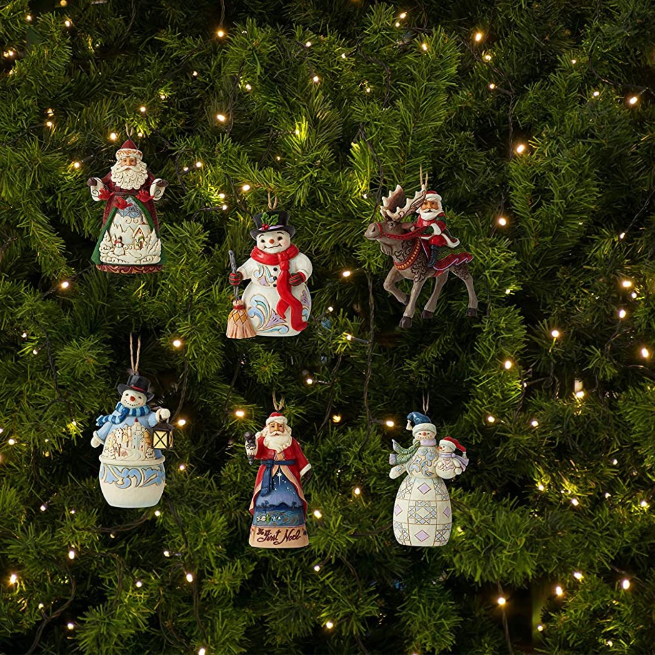 Jim Shore Heartwood Creek Santa with Cardinals Hanging Ornament  Designed by award-winning artist and sculptor Jim Shore for Heartwood Creek. Ornament hangs by jute rope and features a handcrafted look. Item is packed in a branded craft box.