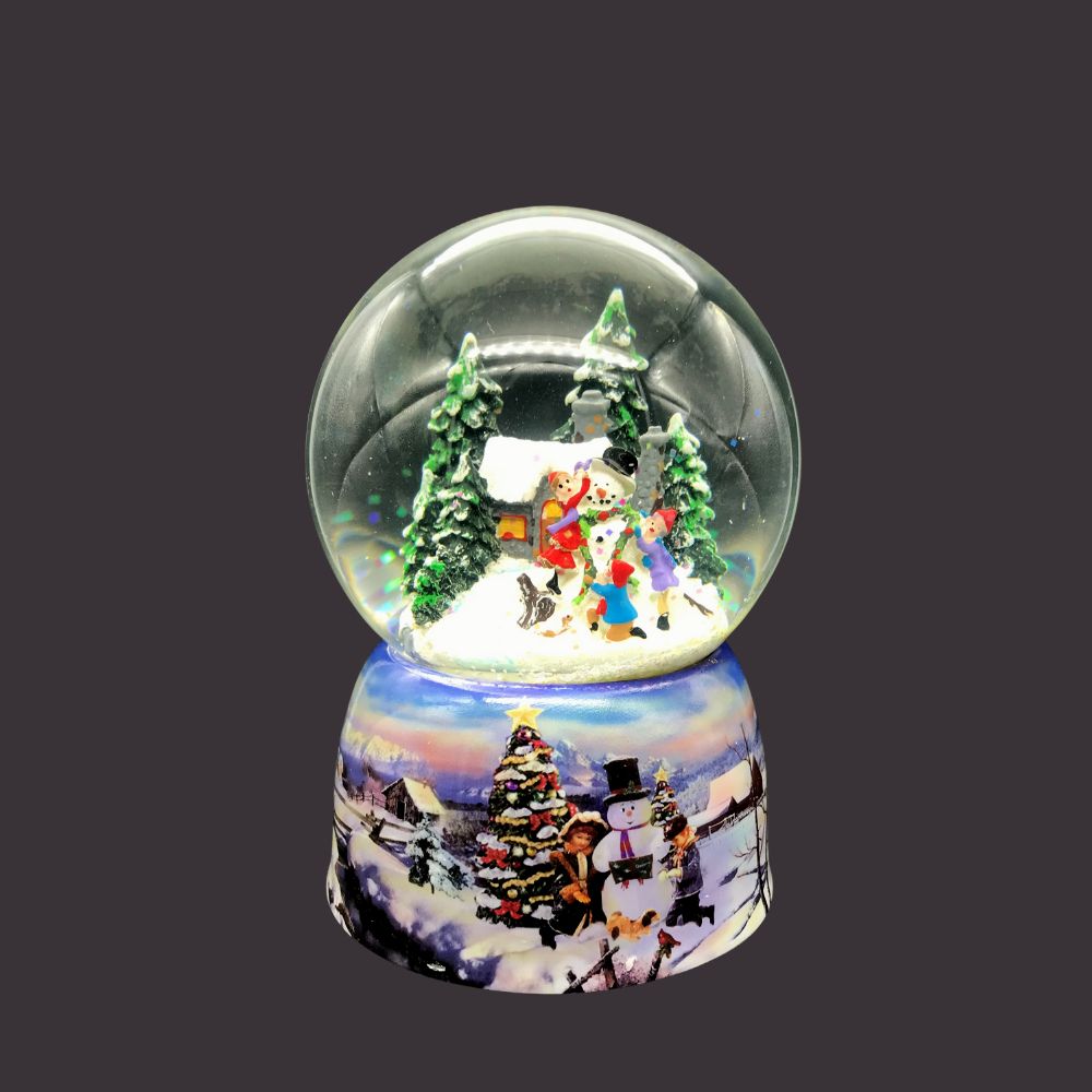 Snow Globe Children Building a Snowman  Kids Building a snowman  The whole globe rotates t the melody “Winter Wonderland”