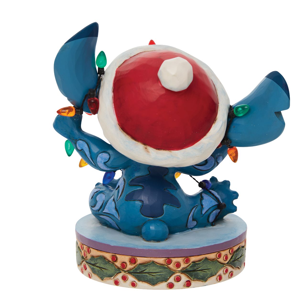 Stitch Wrapped in Lights Figurine  Disney comes home for the holidays with this festive figurine by Jim Shore. Attempting to help his Ohana decorate, Stitch gets caught up in Christmas preparations. Tangled in lights, the little alien tries to escape while wearing a Santa hat.
