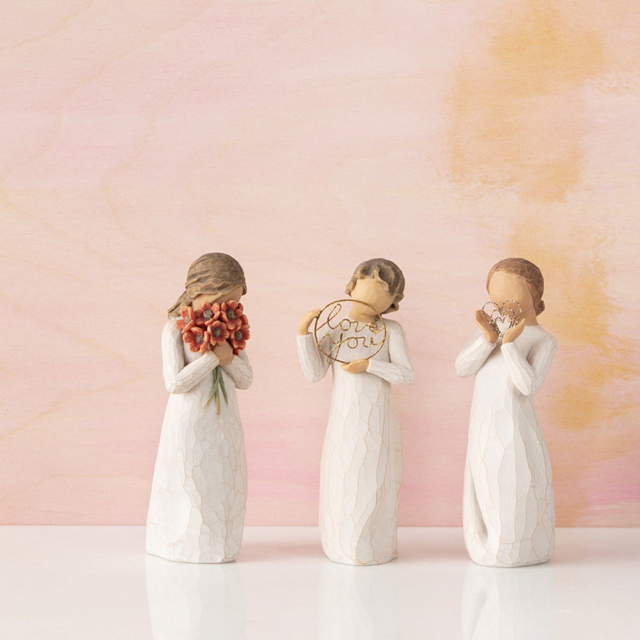 Willow Tree Surrounded by Love  A gift that expresses love and caring ...or for those who love flowers. "I wanted to make a figure with her face in the flowers, taking them in with her senses - smelling them, feeling the petals against her face; feeling safe in that surround.