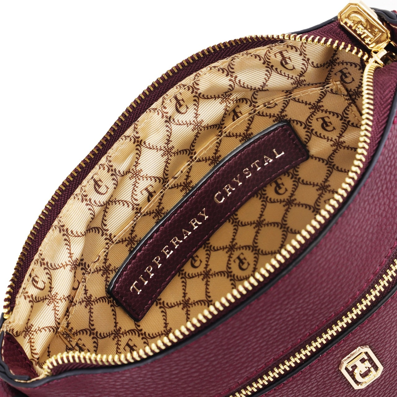 Tipperary Crystal Chelsea Cross Body Pouch - Burgundy New 2022  The Chelsea Cross Body Pouch Burgundy - Rose gold hardware The versatile and trendy Chelsea can be worn as a cross body and also over the shoulder. The Chelsea has an adjustable strap and easily accessible outside pocket and secure front zip pocket.