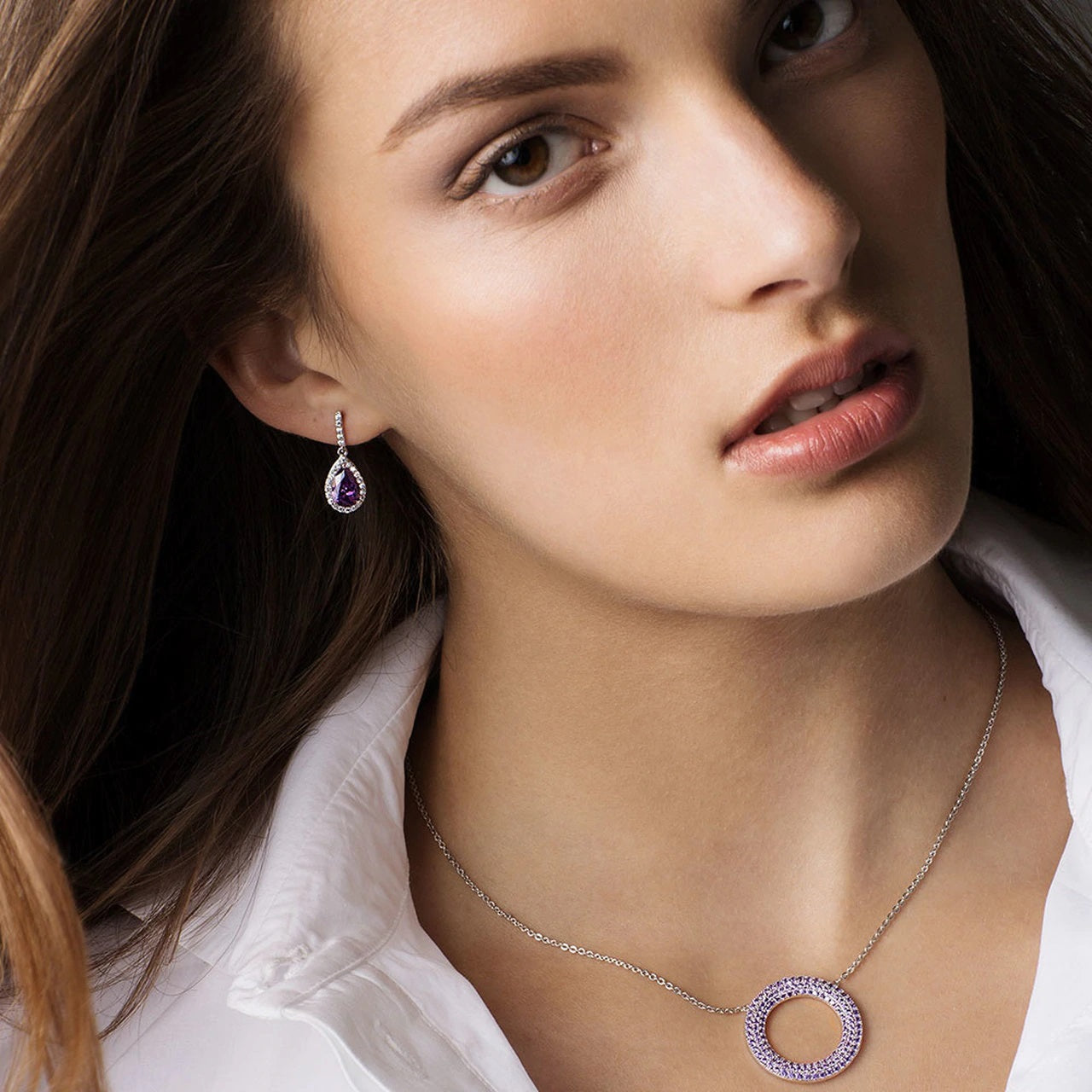 Tipperary Crystal Silver Pear Shape Earrings - Purple  Elegant and dramatic, these exquisite drop earrings are sure to be a favourite. Shimmering with beauty and sophistication they are created in timeless silver. Each dazzling design glistens endlessly with a sparkling pear-shaped centre stone bordered with a halo frame of luminous clear crystals accents.