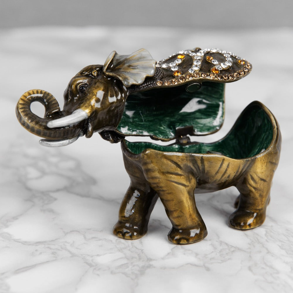Treasured Trinkets - Elephant Curled Trunk  A beautiful, hand painted and crystal finished elephant trinket box from Treasured Trinkets.  Decorated with crystal patterns and floral embellishments, this colourful trinket box is a wonderful ornament to complement a mantelpiece, bookcase or cabine