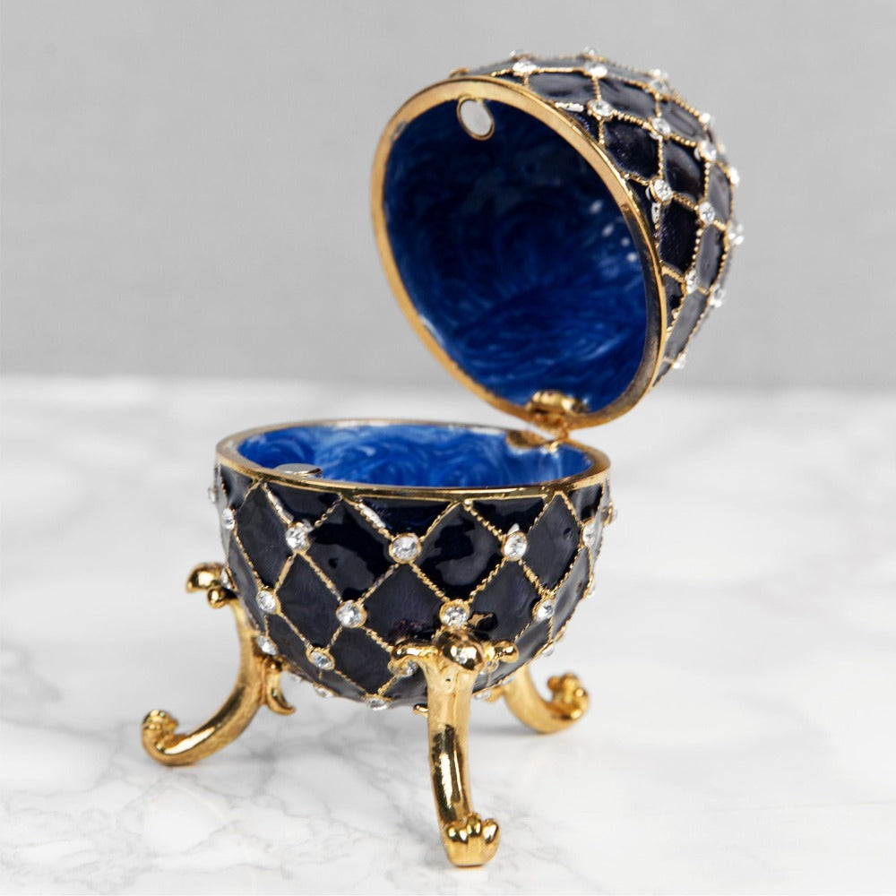 Treasured Trinkets - Large Fabergé Egg Blue  A beautiful, hand painted and crystal finished Fabergé egg trinket box from Treasured Trinkets.  Painted in a resplendent blue colour with stunning gold and crystal patterns, this trinket box is a wonderful ornament to complement a mantelpiece, bookcase or cabinet.