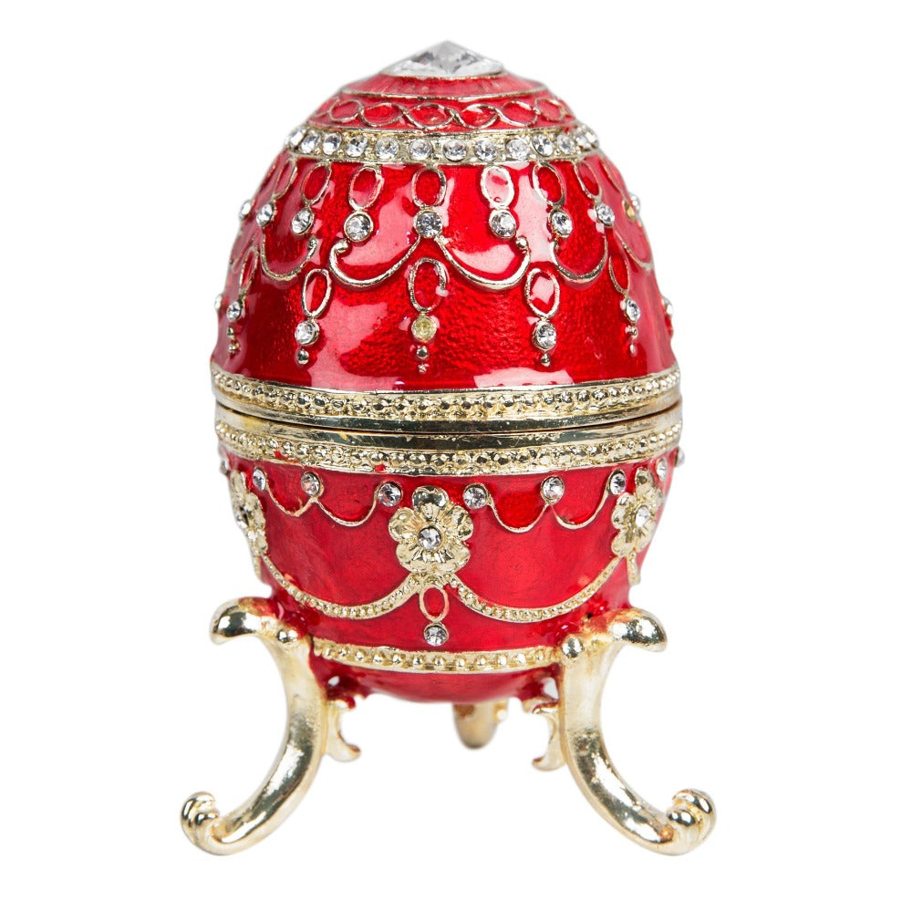 Treasured Trinkets - Large Red Fabergé Egg  A beautiful, hand painted and crystal finished Fabergé egg trinket box from Treasured Trinkets.  Painted in a majestic red colour with stunning gold and crystal patterns, this trinket box is a wonderful ornament to complement a mantelpiece, bookcase or cabinet.