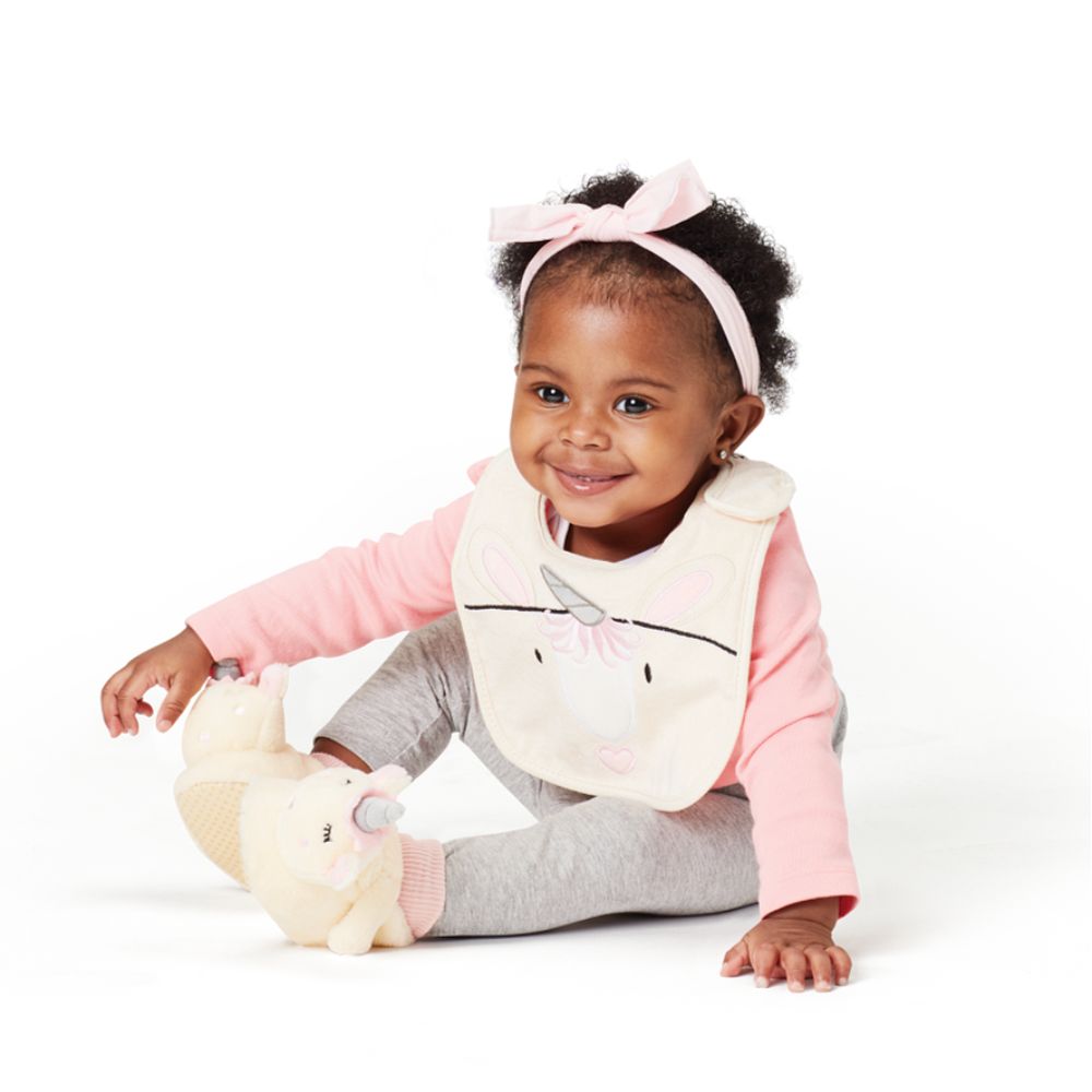 Izzy and Oliver Baby Collection Unicorn Baby Bib  This super soft and super cute Unicorn bib is perfect for little ones. Featuring a sweet Unicorn face that is embroidered for safety, Velcro fastening for easy wear and made from 100% cotton, it can be machine washed. This is part of the Izzy and Oliver Baby collection.