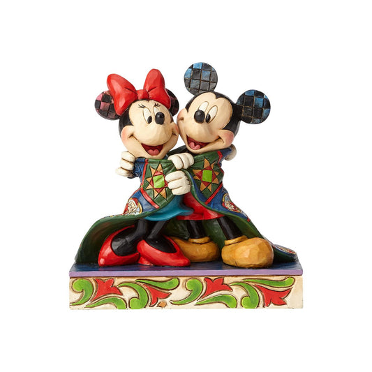 Jim Shore Warm Wishes Mickey and Minnie Mouse Figurine  Remember those cosy winter nights and lazy mornings, lounging in your new Christmas PJ's sipping hot chocolate and watching your favourite Disney film? This was the inspiration for this Mickey Mouse personality pose by Jim Shore. 