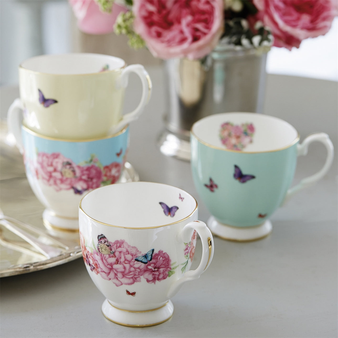 Royal Albert Miranda Kerr Gratitude Mug  Delicate, delightful and totally Miranda, makes this item the perfect gift for the sophisticated and feminine woman, who enjoys to celebrate with friends or simply when she needs to take time for herself with a nice mug of tea or coffee. 'Gratitude' features a sophisticated scattering of peach and pink peony flowers; peppered with signature multi-coloured, purple and turquoise butterflies.