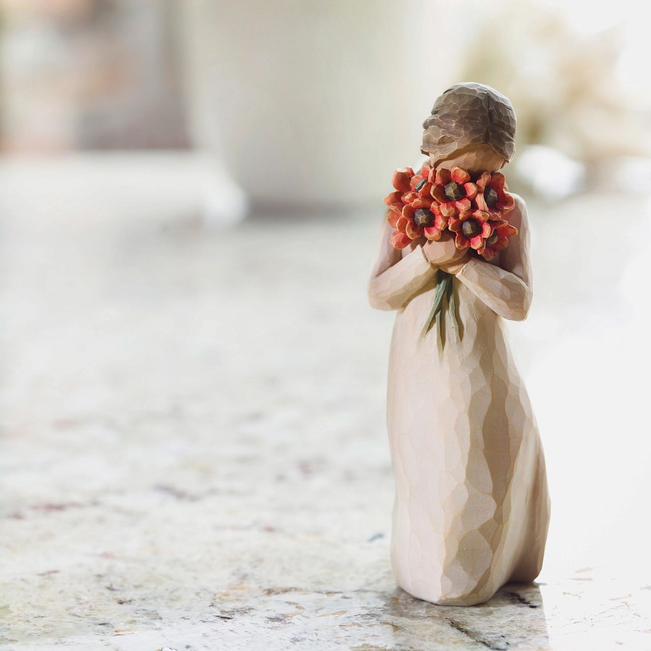 Willow Tree Surrounded by Love  A gift that expresses love and caring ...or for those who love flowers. "I wanted to make a figure with her face in the flowers, taking them in with her senses - smelling them, feeling the petals against her face; feeling safe in that surround.
