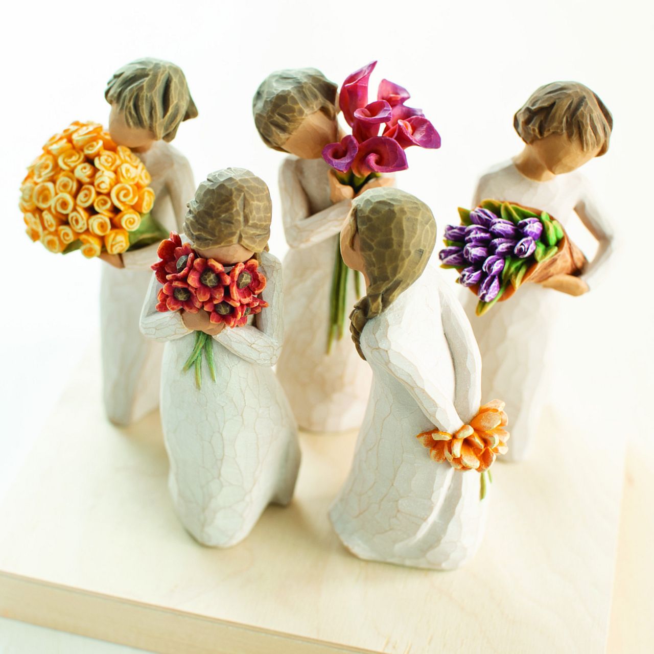 Willow Tree Surrounded by Love  A gift that expresses love and caring ...or for those who love flowers. "I wanted to make a figure with her face in the flowers, taking them in with her senses - smelling them, feeling the petals against her face; feeling safe in that surround.