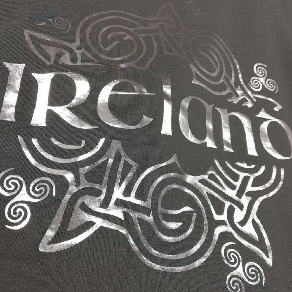 Women's Ireland Celtic Hologram T-Shirt Pewter Silver  This pewter silver T-shirt features intricate Celtic details, perfect for expressing one's Irish heritage.
